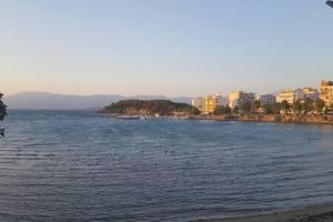 a large body of water with buildings in the background at cELLATE cozy home in Chalkida