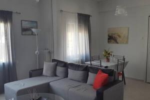a living room with a couch and a table at cELLATE cozy home in Chalkida