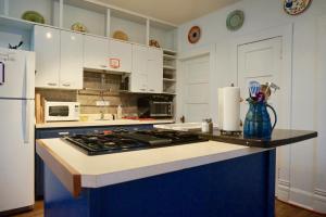 a kitchen with white cabinets and a stove top oven at The Salida Inn and Hostel in Salida