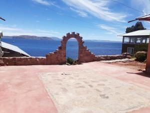 a brick archway in front of the water at Posada de Oliver in Llachon