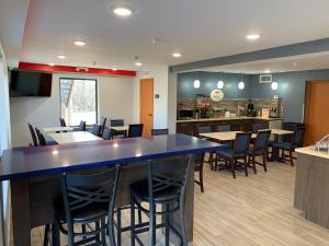 a restaurant with a large blue counter and chairs at Super 8 by Wyndham Cookeville, TN in Cookeville