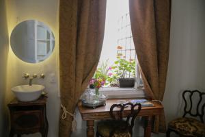 a bathroom with a table with a sink and a window at Casa Turin in Mexico City