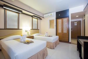 Postel nebo postele na pokoji v ubytování Asia Cha-am Hotel