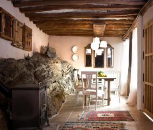 a kitchen and dining room with a wood stove at Casa Grande in Enciso