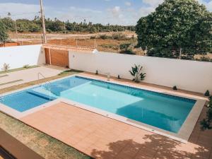 a swimming pool in the backyard of a house at Mansão Beberibe in Beberibe
