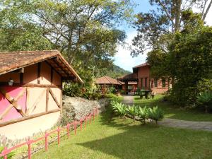 een resort met een tuin en een gebouw bij Country Ville Hotel in Teresópolis