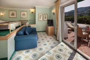 a hotel room with a bed and a living room at Hotel Continental Ischia in Ischia