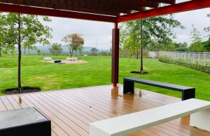 a wooden deck with a bench and a yard at Menlyn Maine Residence 11th Floor Apartment in Pretoria