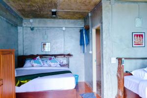 Postel nebo postele na pokoji v ubytování Baan Tubkaek Hotel