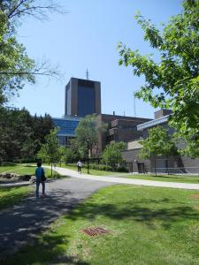 a person standing in the grass in front of a building at Carleton University – Ottawa in Ottawa