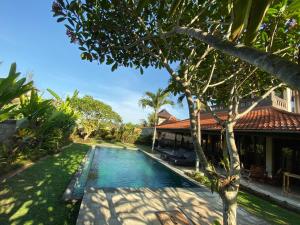 an image of a swimming pool in front of a house at Rumah Dadong in Ubud