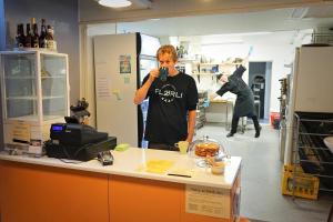 a man taking a picture of a counter in a kitchen at Flørli 4444 Hostel in Fløyrli