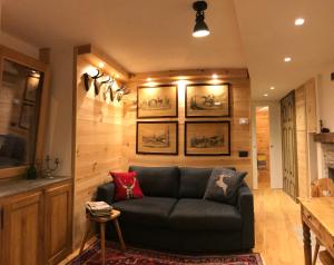 a living room with a couch and a table at Chalet Monaci alla Fontana "Junior suite" in Albosaggia