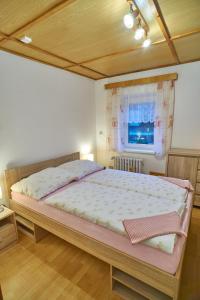 um quarto com uma cama grande e uma janela em Penzion Mona em Jeseník