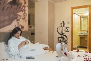 a woman laying in a hospital bed with a spoon at Melliber Appart Hotel in Casablanca