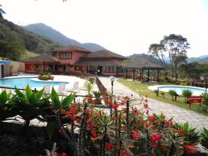 a resort with two swimming pools and some plants at Country Ville Hotel in Teresópolis