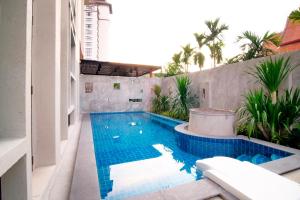 a swimming pool on the side of a building at Tapae Gate Villa in Chiang Mai