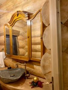 a bathroom with a sink and a mirror at The Mountain's Sea Chalet in Colibiţa