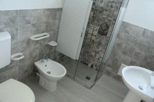 a bathroom with a shower and a toilet and a sink at Villa Simonetta in Alliste +57 photos
