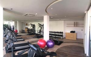 a gym with treadmills and exercise bikes in it at La Vida Samui in Chaweng