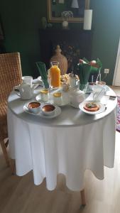 a white table with food and drinks on it at Les Patis in Vouvray