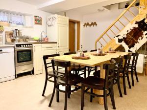 
a kitchen with a table and chairs and a refrigerator at New Hostel Berlin Mitte in Berlin
