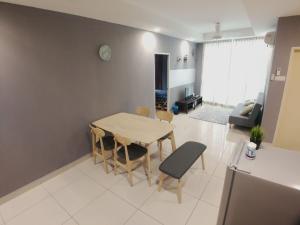a kitchen and living room with a table and chairs at Central Residence Homestay2 @ Sungai Besi, Kuala Lumpur in Kuala Lumpur