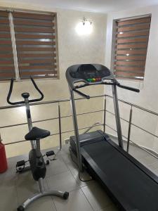 a gym with a treadmill and a chair in a room at KM 80 Restaurant & Hotel in Mavrodolu