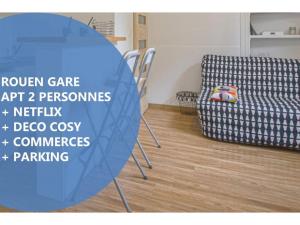 a table in a room with a chair and a couch at CosyRouen Gare in Rouen