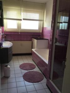 a bathroom with a tub and a sink at Ferienwohnung Esmeralda in Oppenheim