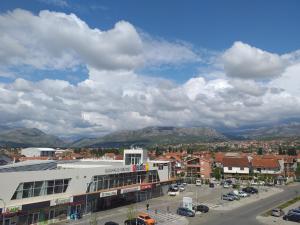 a city with cars parked in a parking lot at Aphrodite Apartment in Podgorica
