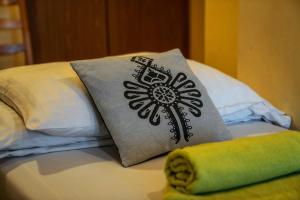 a pillow with a flower on it sitting on a bed at OW Zakopiec in Zakopane