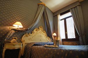 Postel nebo postele na pokoji v ubytování Hotel Torino