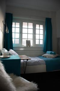 Rúm í herbergi á Bed & Breakfast Hotel Zandvoort