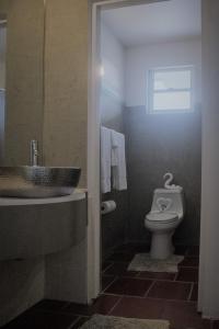 a bathroom with a sink and a toilet at BOHO Beach Club in Boqueron