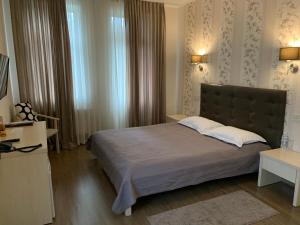 a bedroom with a large bed and a window at Viktoria Park Hotel in Bucha