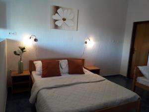 a bedroom with a bed with two tables and two lights at Delfin Apartments in Sveti Juraj
