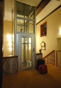 a room with a glass door in a hotel room at Hotel Torino in Venice