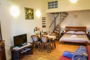 a living room with a bed and a dining room at Apartman Rudi in Samobor