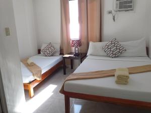 Postel nebo postele na pokoji v ubytování Zenith Inn & Resto Bar