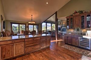 an open kitchen with wooden cabinets and a large island at Breck Mtn Home with Hot Tub and Game Room! in Breckenridge