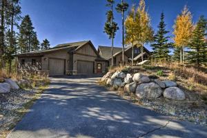 a house with a driveway leading to a garage at Breck Mtn Home with Hot Tub and Game Room! in Breckenridge