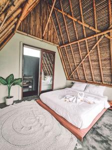 a bedroom with a large bed and a large rug at Capila Villa Bali in Canggu