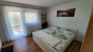 Postel nebo postele na pokoji v ubytování Mandula Apartmanok