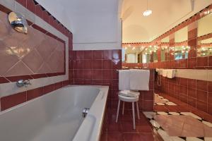 a bathroom with a tub and a toilet and a sink at Hotel Luna Convento in Amalfi