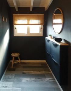 a bathroom with a blue cabinet and a mirror at Country House "1892" in Kallithéa