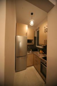 a kitchen with a stainless steel refrigerator at Denise Luxury Apartment-Centre of Athens,Kolonaki in Athens