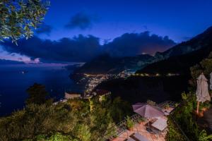 a view of the amalfi coast at night at Ville Olimpo in Positano