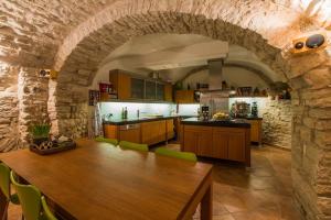 a kitchen with a wooden table and a stone wall at Casa Cristina Bed&Breakfast in Ripabottoni