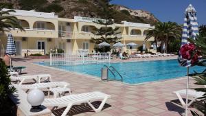 a resort with a swimming pool and a building at Kontessa Apartments in Kefalos